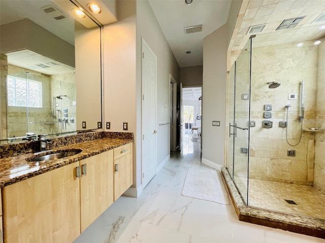 9060 Heritage Bay Cir, Orlando, FL 32836 - bathroom with vanity, a shower stall, marble finish floor, baseboards, and visible vents