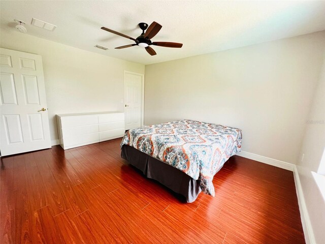 9060 Heritage Bay Cir, Orlando, FL 32836 - bedroom featuring baseboards, visible vents, wood finished floors, and ceiling fan