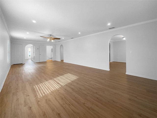 unfurnished living room with light hardwood / wood-style floors, ceiling fan, and crown molding