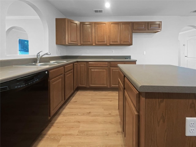 kitchen with black dishwasher, light hardwood / wood-style floors, crown molding, and sink