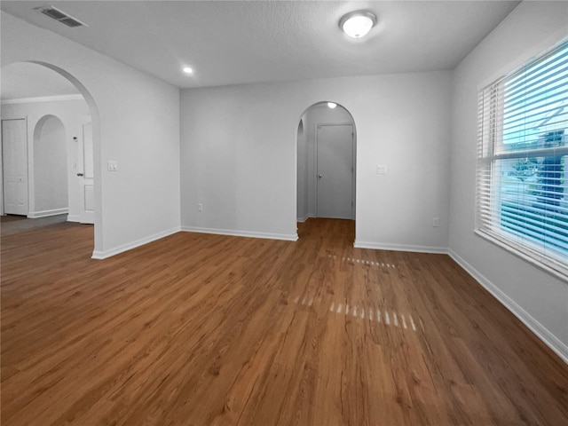 unfurnished room with dark wood-type flooring