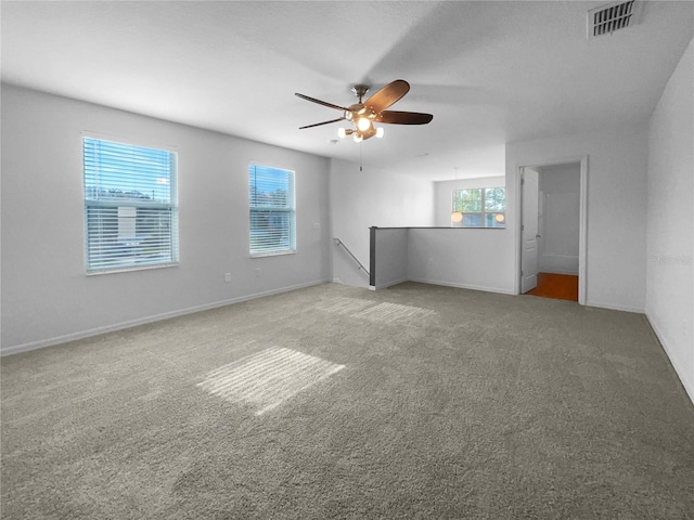 carpeted spare room with ceiling fan