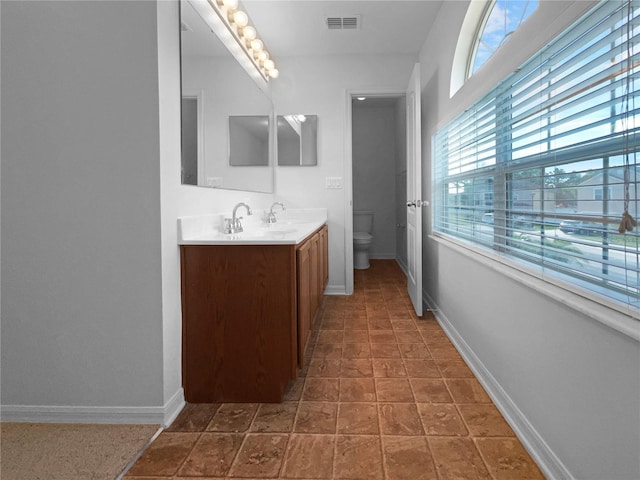 bathroom with tile patterned floors, vanity, and toilet