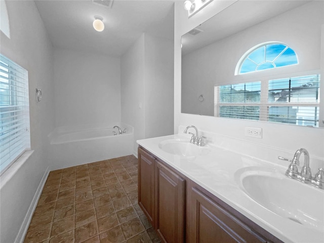 bathroom featuring a washtub and vanity