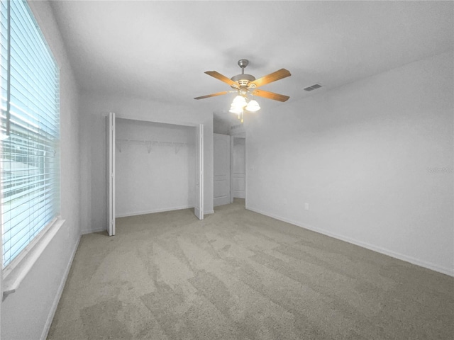 unfurnished bedroom with ceiling fan and light colored carpet