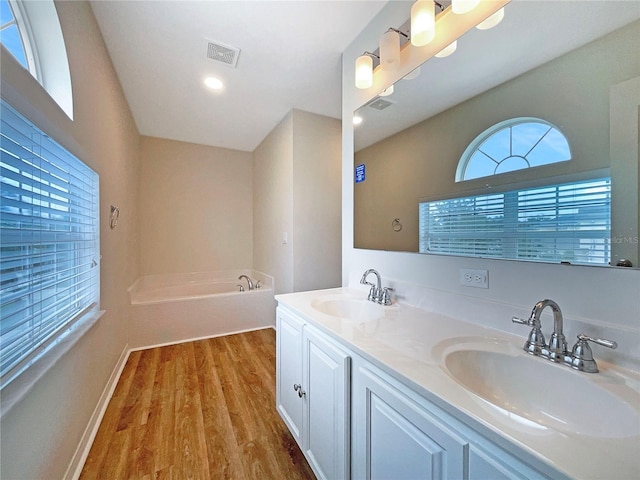 3444 97th Ln E, Palmetto, FL 34221 - full bath featuring wood finished floors, double vanity, and a garden tub