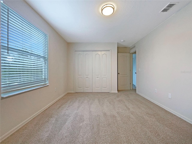 3444 97th Ln E, Palmetto, FL 34221 - unfurnished bedroom featuring light carpet and a closet