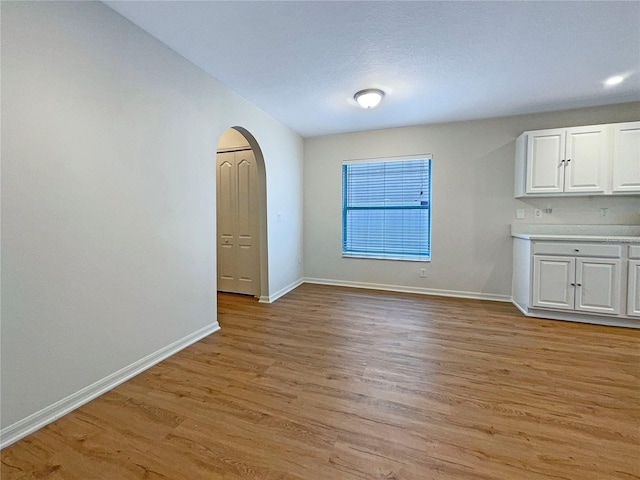 3444 97th Ln E, Palmetto, FL 34221 - unfurnished dining area featuring arched walkways and light wood finished floors