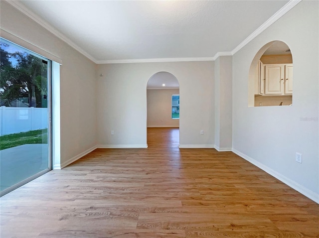 3444 97th Ln E, Palmetto, FL 34221 - spare room with arched walkways, light wood-style flooring, and crown molding