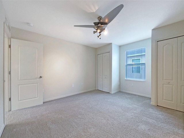 3444 97th Ln E, Palmetto, FL 34221 - unfurnished bedroom featuring two closets, carpet floors, and ceiling fan