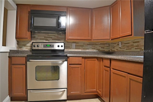 kitchen with tasteful backsplash and stainless steel electric stove