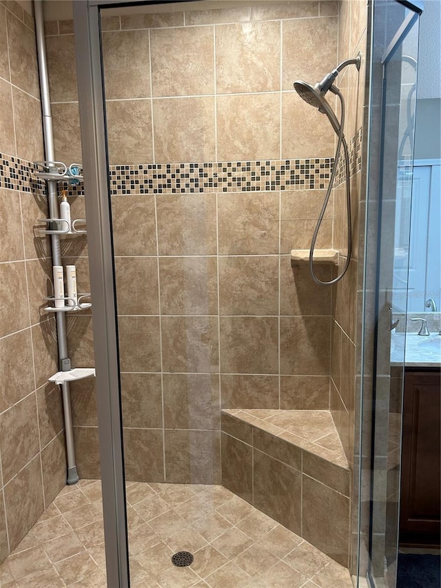 bathroom featuring a shower stall and vanity