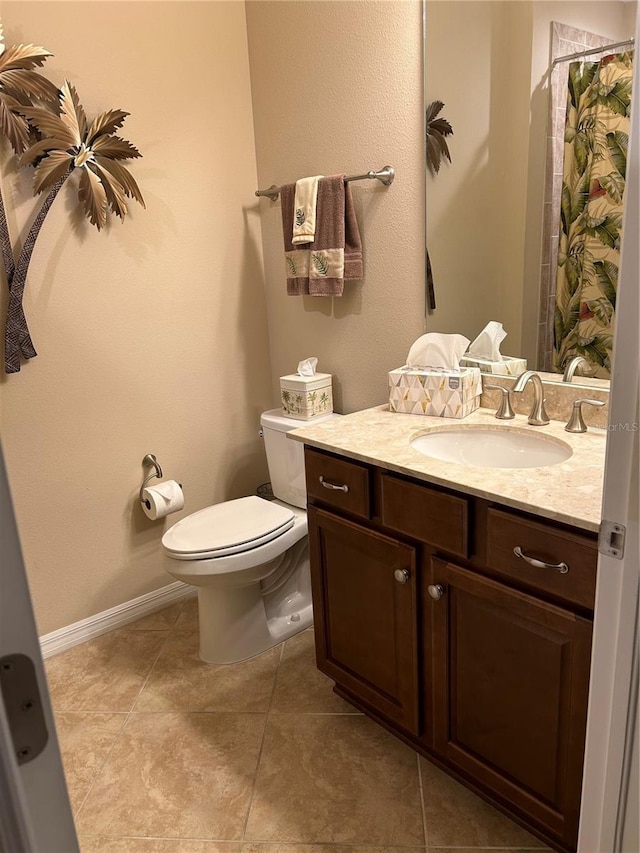 bathroom with tile patterned flooring, toilet, a shower with shower curtain, vanity, and baseboards