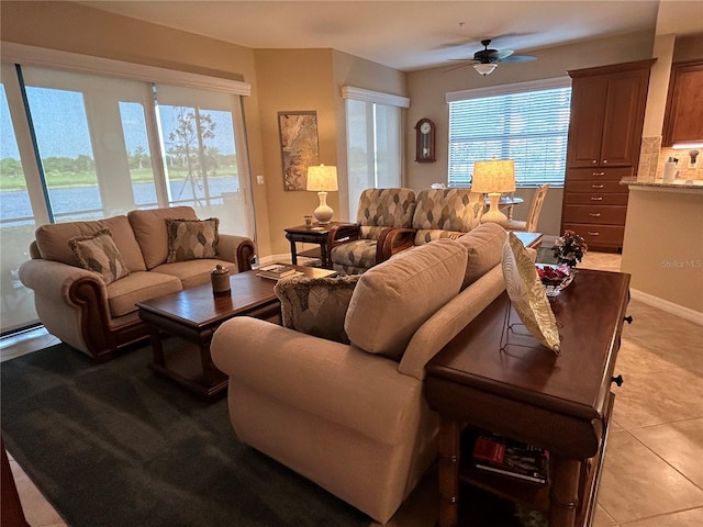 living room featuring light tile patterned floors and a ceiling fan