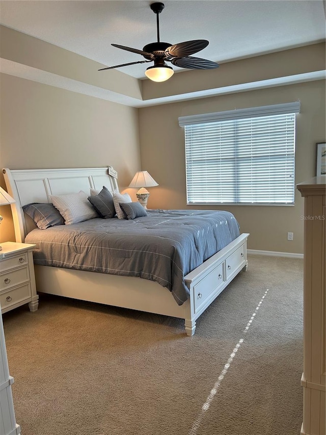 bedroom featuring a ceiling fan, carpet, and baseboards