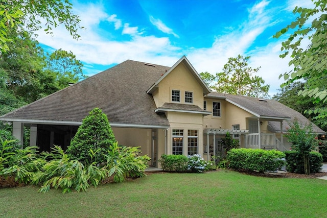 back of property featuring a lawn