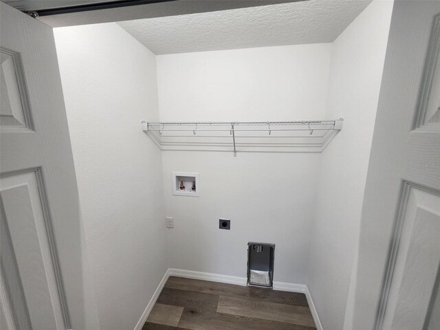 laundry room with dark wood finished floors, laundry area, hookup for a washing machine, electric dryer hookup, and a textured ceiling