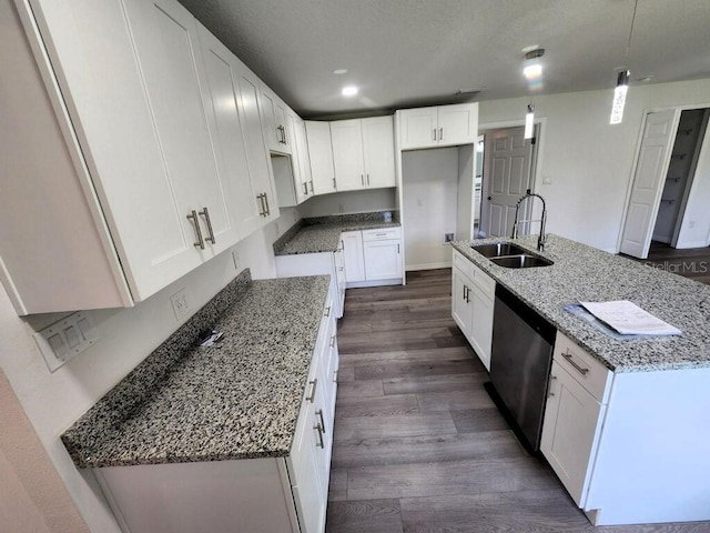 kitchen with white cabinetry, dark hardwood / wood-style floors, sink, an island with sink, and stone countertops