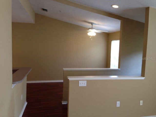 hallway with dark wood-style flooring, recessed lighting, visible vents, and baseboards