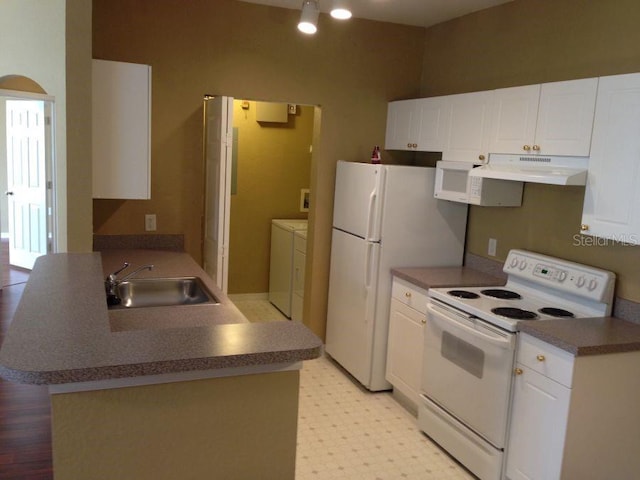 kitchen featuring white cabinetry, a sink, separate washer and dryer, white appliances, and under cabinet range hood