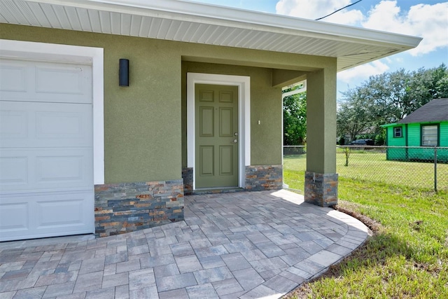 doorway to property featuring a lawn