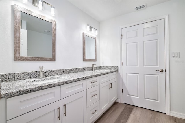 bathroom featuring vanity and hardwood / wood-style flooring