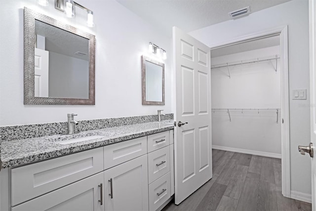 bathroom featuring wood-type flooring, a textured ceiling, and vanity