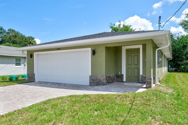 ranch-style house with a garage and a front lawn