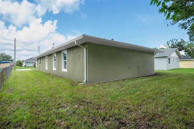 view of side of home featuring a yard