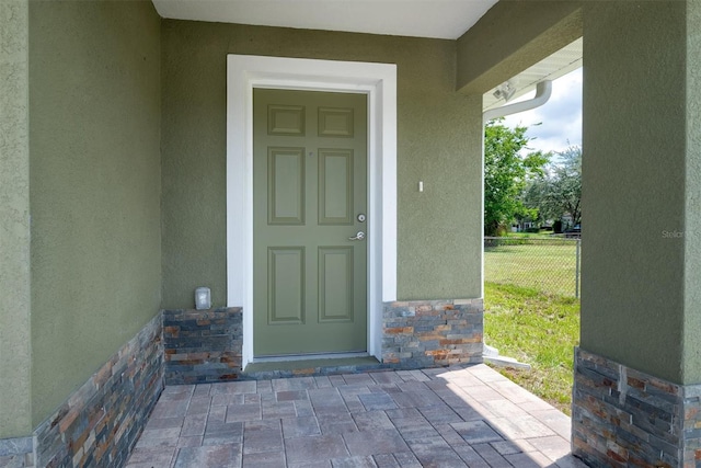 doorway to property with a yard