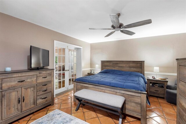 tiled bedroom with ceiling fan and french doors