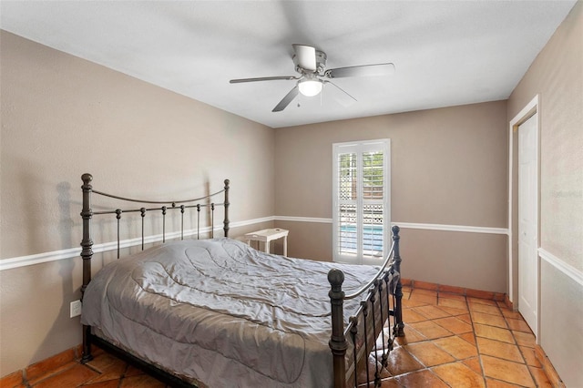 tiled bedroom with ceiling fan