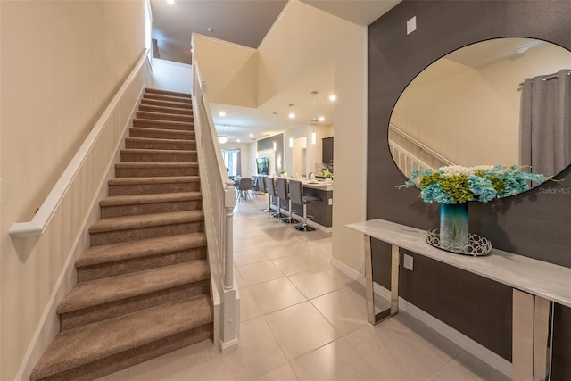 stairs featuring light tile patterned floors