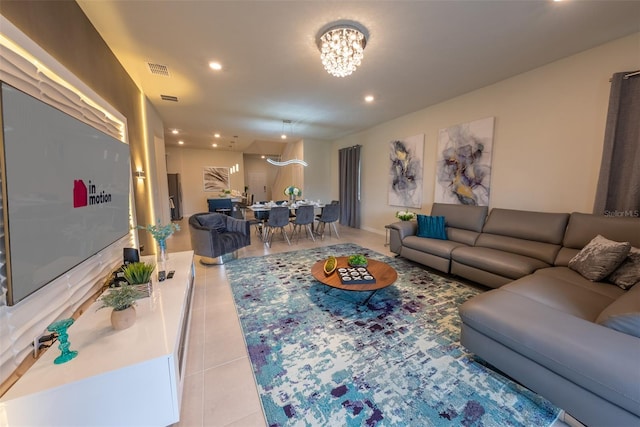 living room with a notable chandelier and tile patterned floors