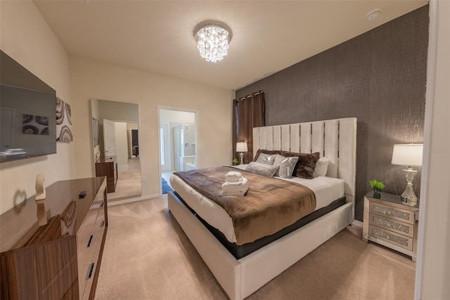 carpeted bedroom with a notable chandelier and ensuite bath