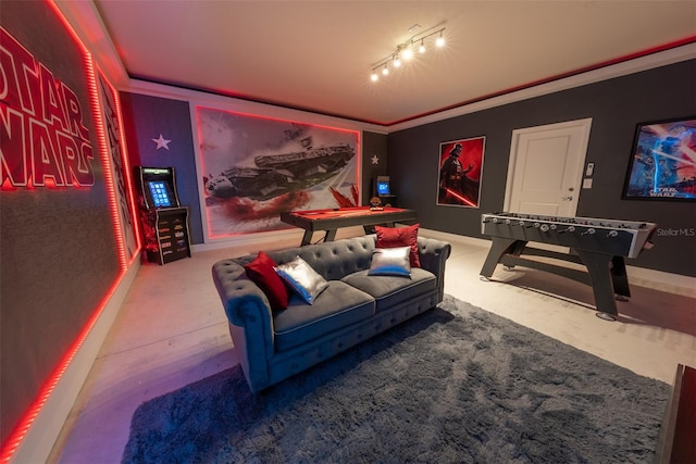 carpeted cinema room with crown molding and track lighting