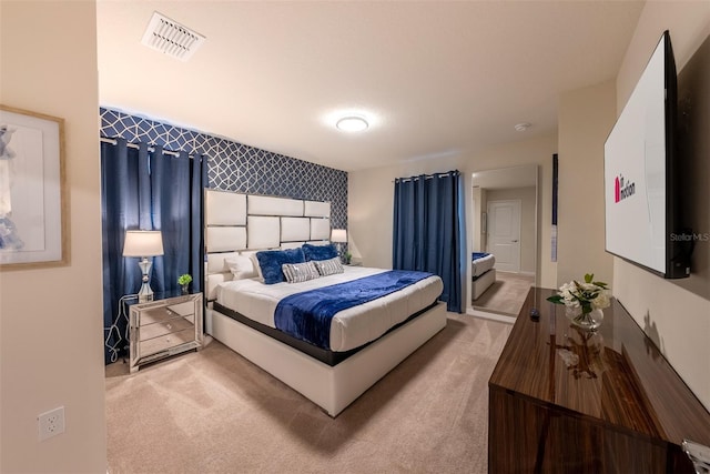 carpeted bedroom with visible vents, wallpapered walls, and an accent wall