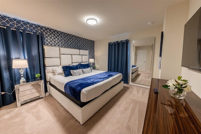 carpeted bedroom featuring a textured ceiling and wallpapered walls