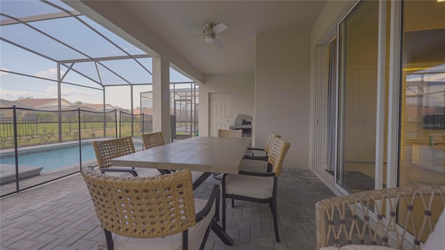 exterior space featuring glass enclosure, outdoor dining space, and an outdoor pool