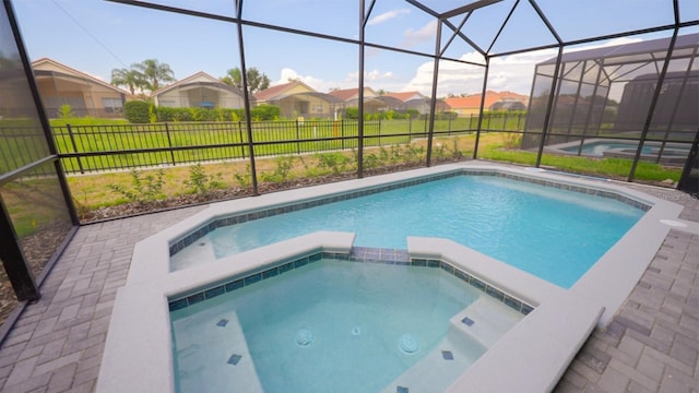 view of swimming pool featuring an in ground hot tub and glass enclosure