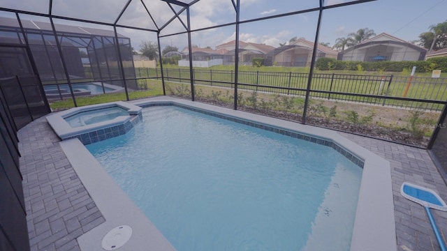 view of swimming pool featuring a lanai, fence, a residential view, and a patio