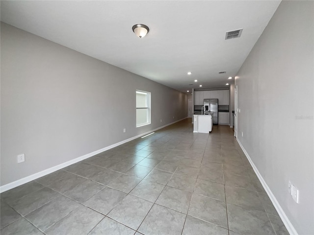 unfurnished living room with light tile patterned floors