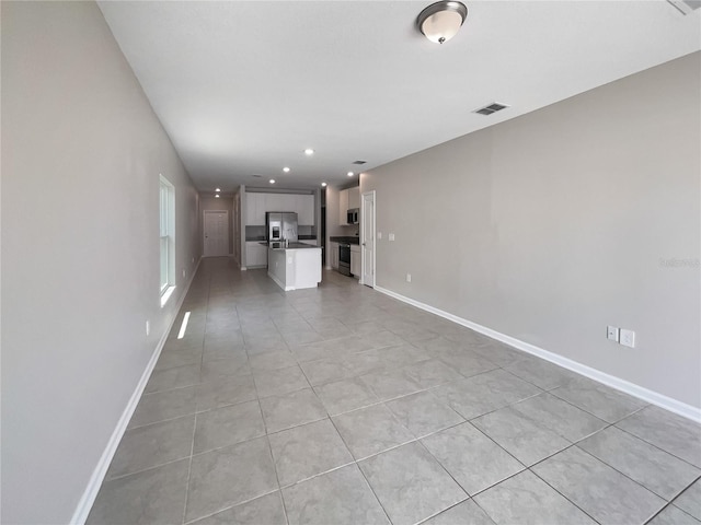 unfurnished living room with light tile patterned floors