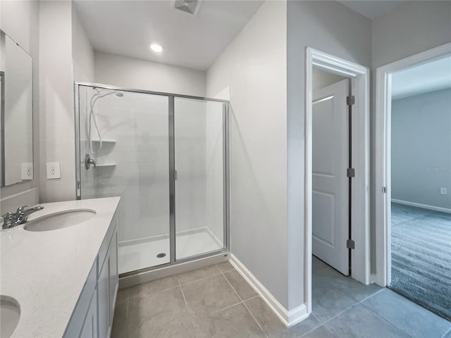 bathroom featuring an enclosed shower, vanity, and tile patterned floors