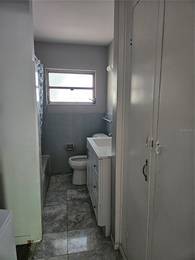 full bathroom featuring tile patterned flooring, toilet, vanity, tile walls, and shower / tub combo