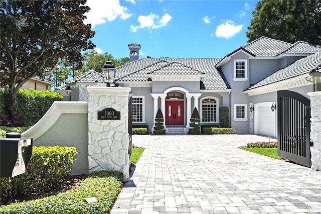 mediterranean / spanish-style home featuring a garage