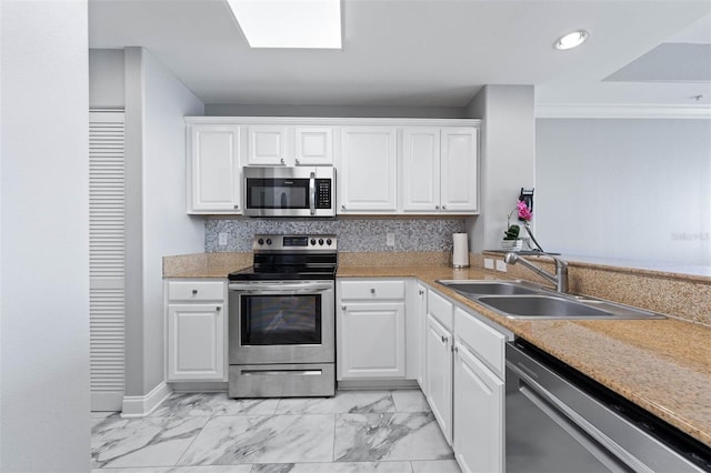 kitchen featuring sink, white cabinets, and appliances with stainless steel finishes