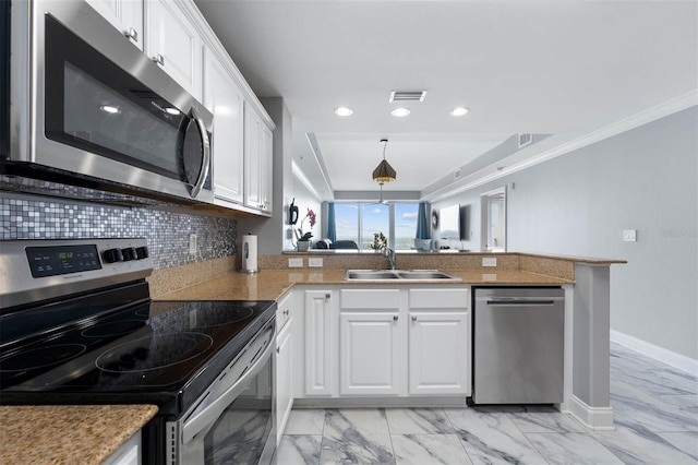 kitchen with kitchen peninsula, stainless steel appliances, white cabinets, and sink