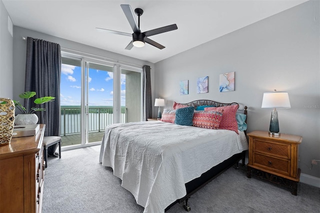 carpeted bedroom featuring ceiling fan, access to exterior, and a water view