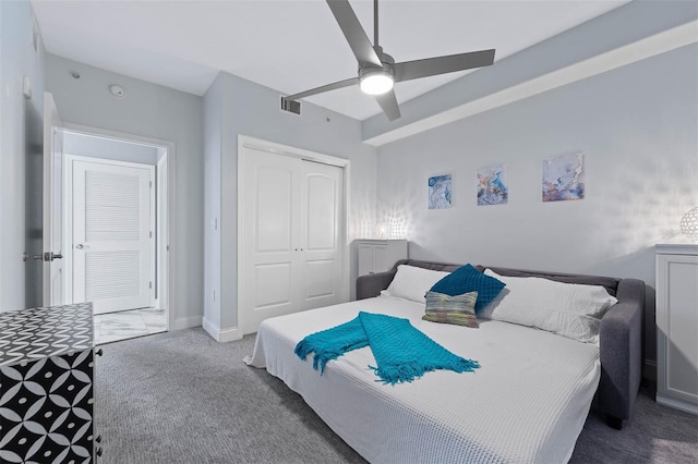 carpeted bedroom with a closet and ceiling fan